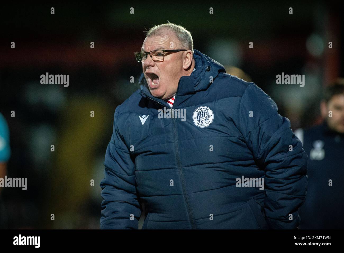 Steve Evans, football manager, Stevenage FC on touchline during game at