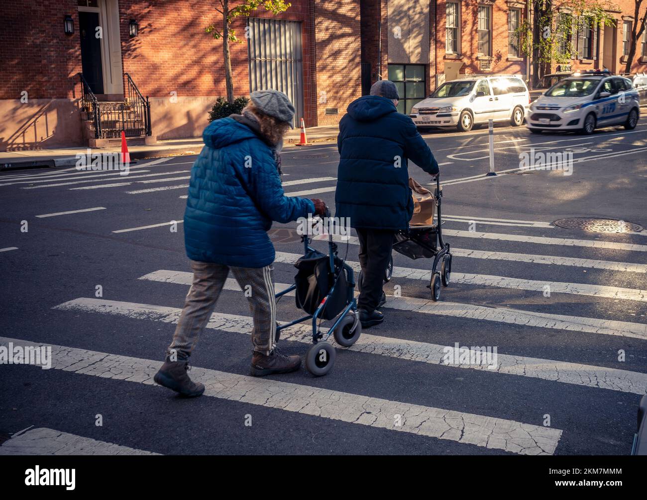 An elderly couple crosses an intersection in Greenwich Village in New York on Saturday, November 19, 2022.  (© Richard B. Levine) Stock Photo