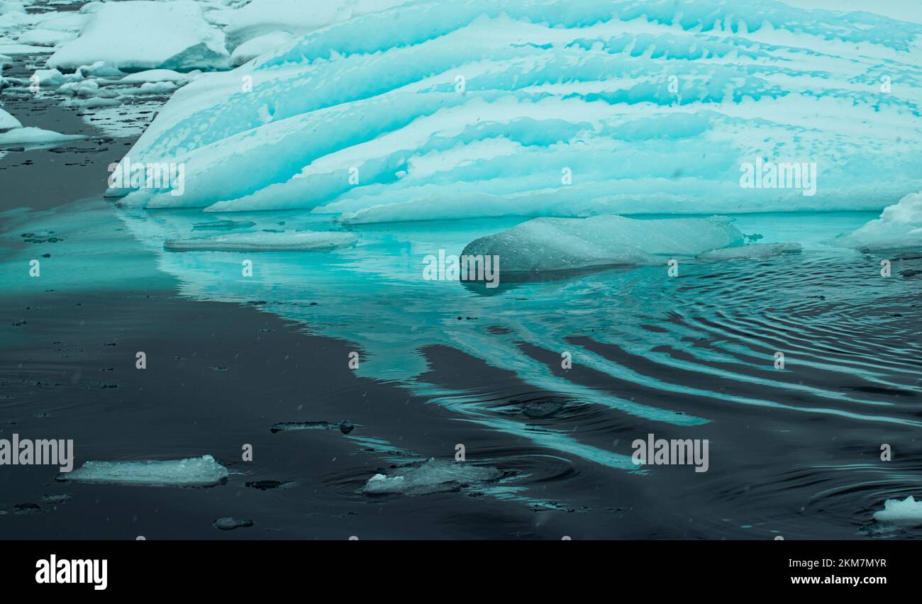 Icebergs floating in the still water around Enterprise Island.  With bright green-blue colors and ice layers creating groves. Stock Photo