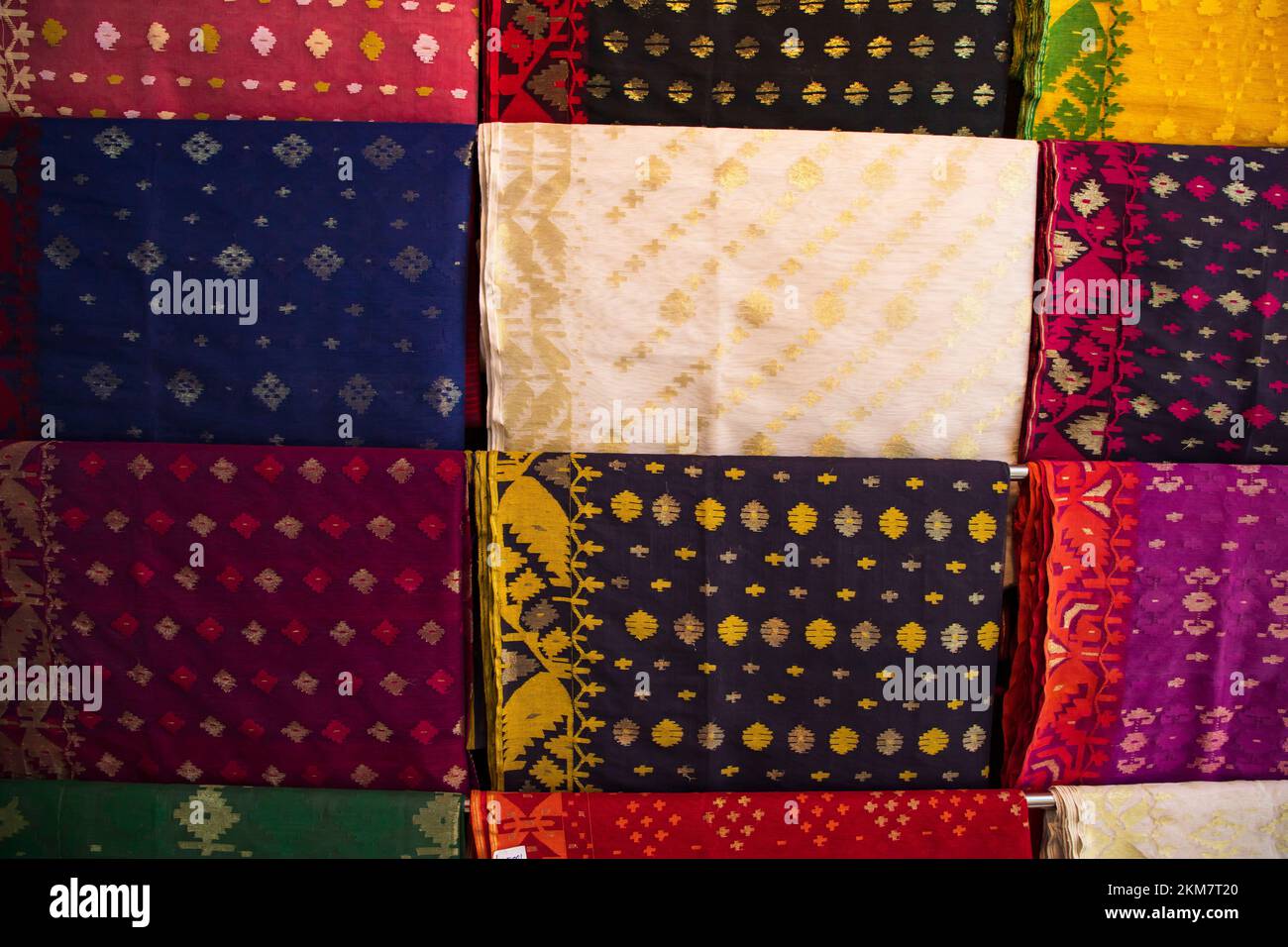 Bangladeshi Women,s Traditional Colorful Jamdani saree hanging in the retail Showrooms. Colorful Jamdani Saree Texture Background Stock Photo