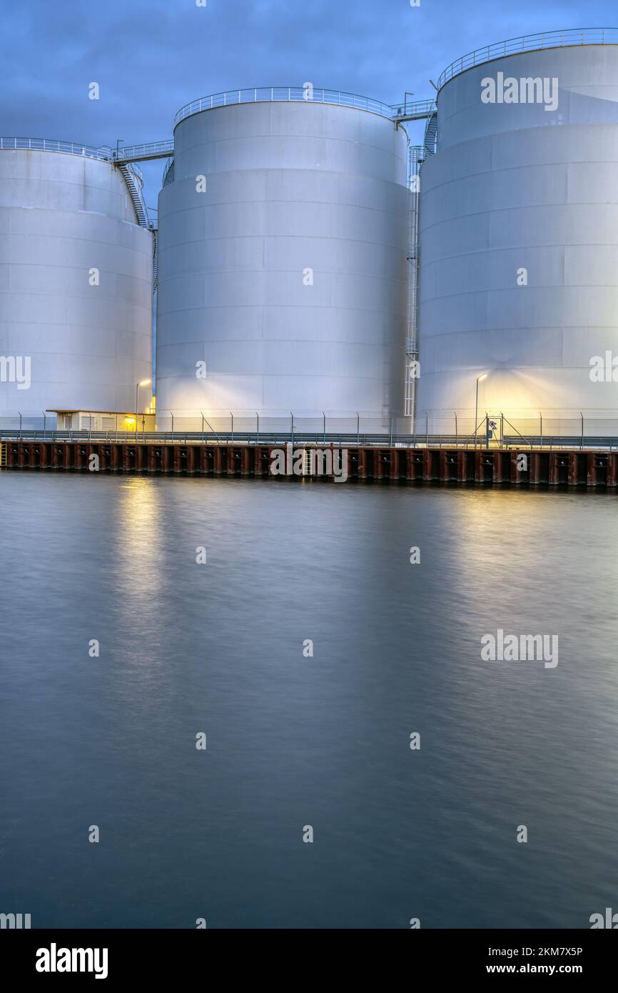 Big oil storage tanks at dusk seen in Berlin Stock Photo