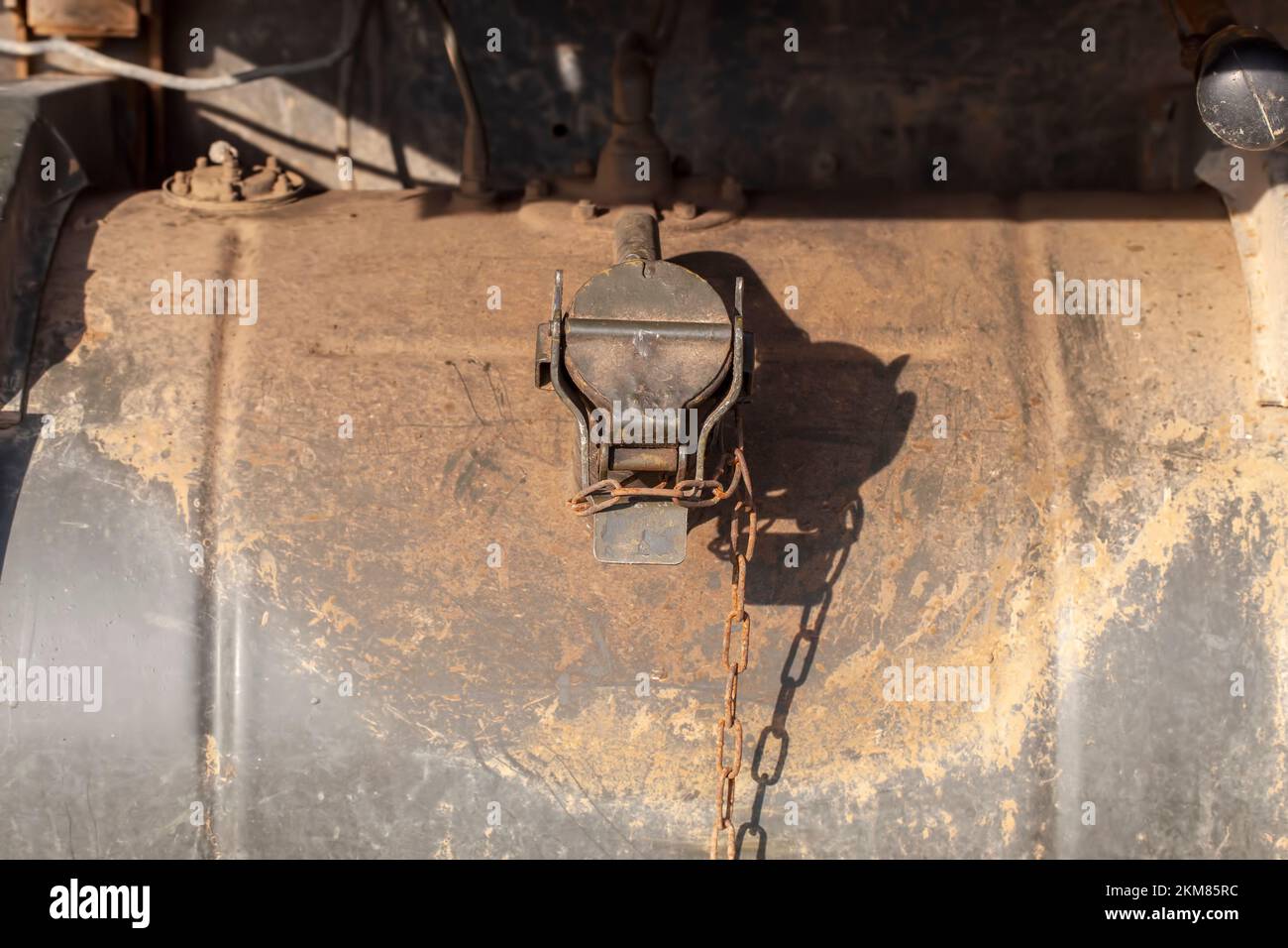 the old external gas tank from the truck is covered in dirt and rust