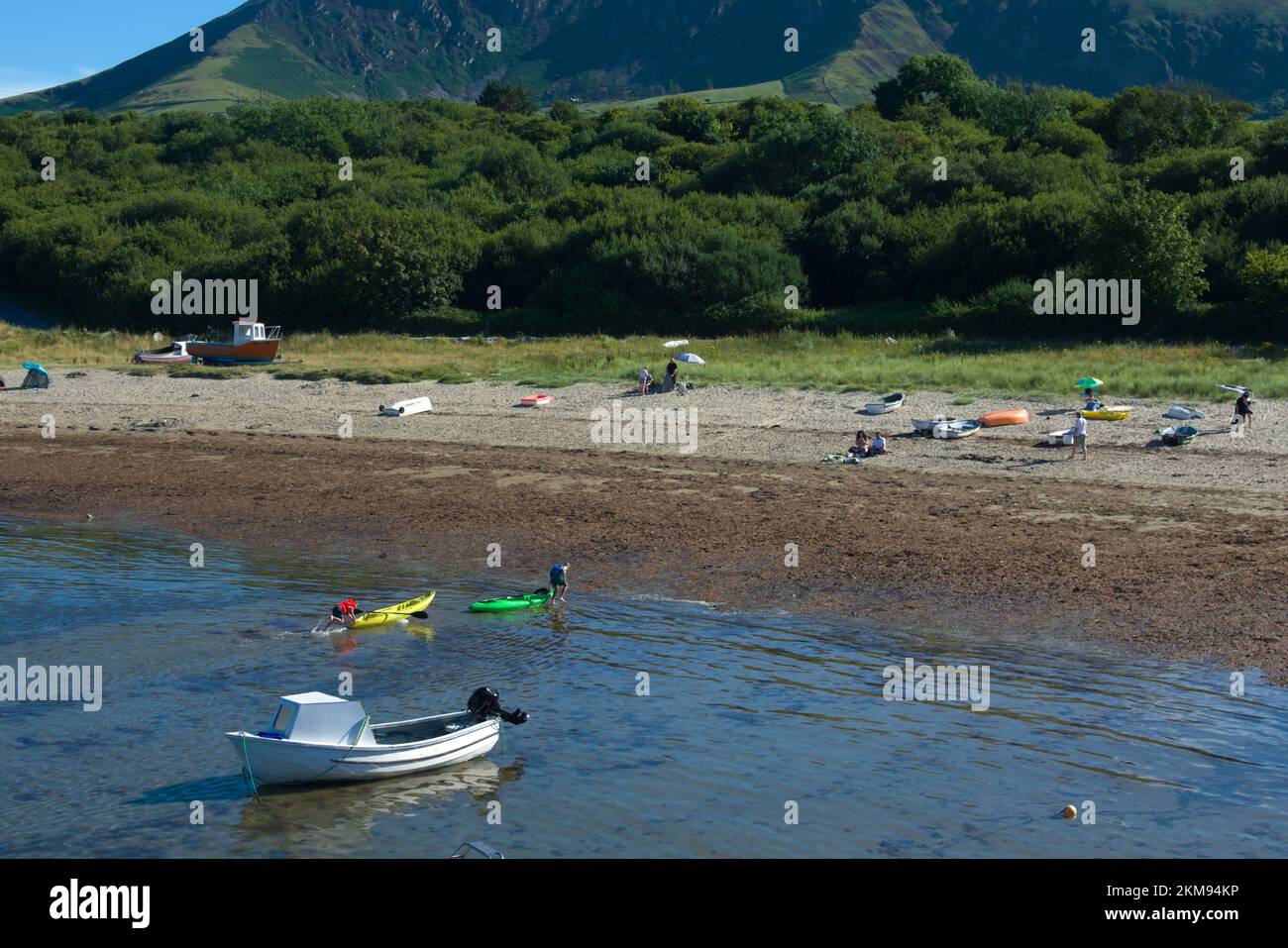 Trefor - Wales - September 8 2033 :  Charming small village on the Llyn Peninsula north wales. Seaside scene with holiday makers relaxing on the beach Stock Photo