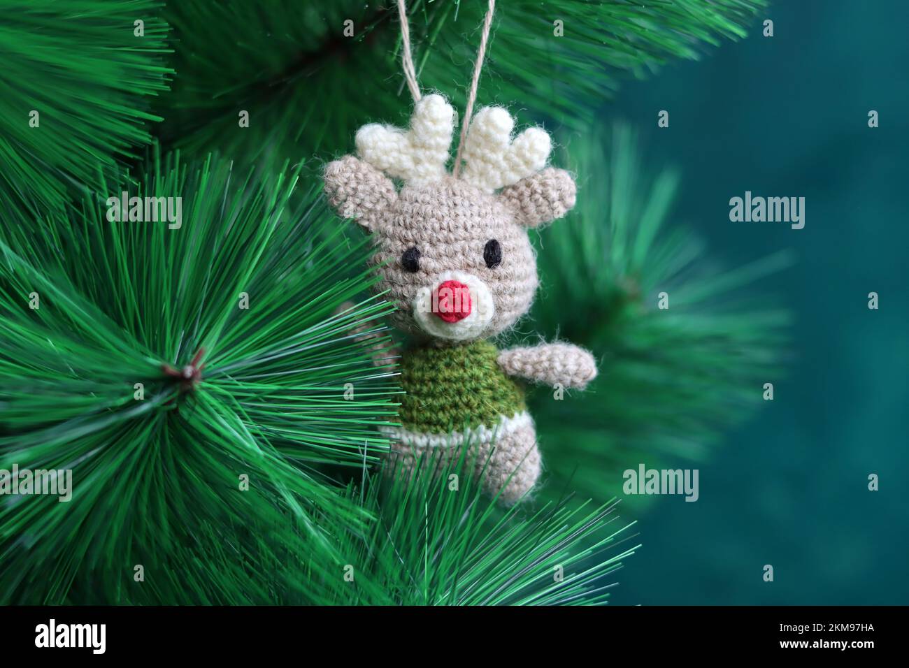 Cute hand made Christmas ornament. Crochet Reindeer close up photo