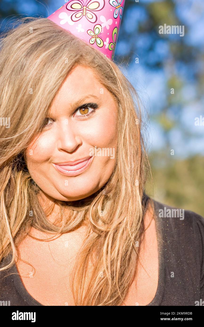 Cute Party Girl In Birthday Party Hat Poking Out Tongue Stock Photo Alamy