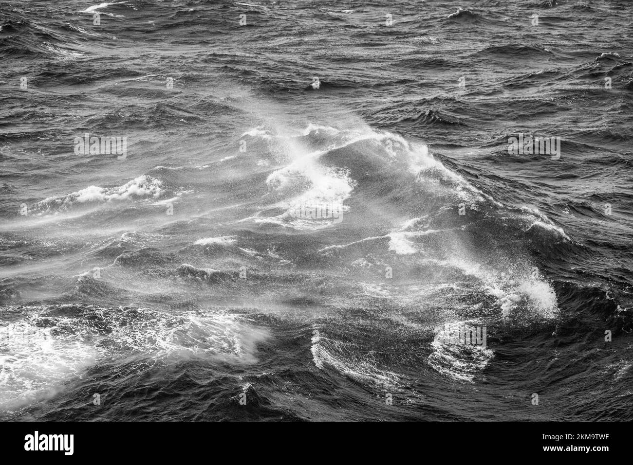 Boat wake waves in the Drake Passage, causing spray to come off the water. Stock Photo