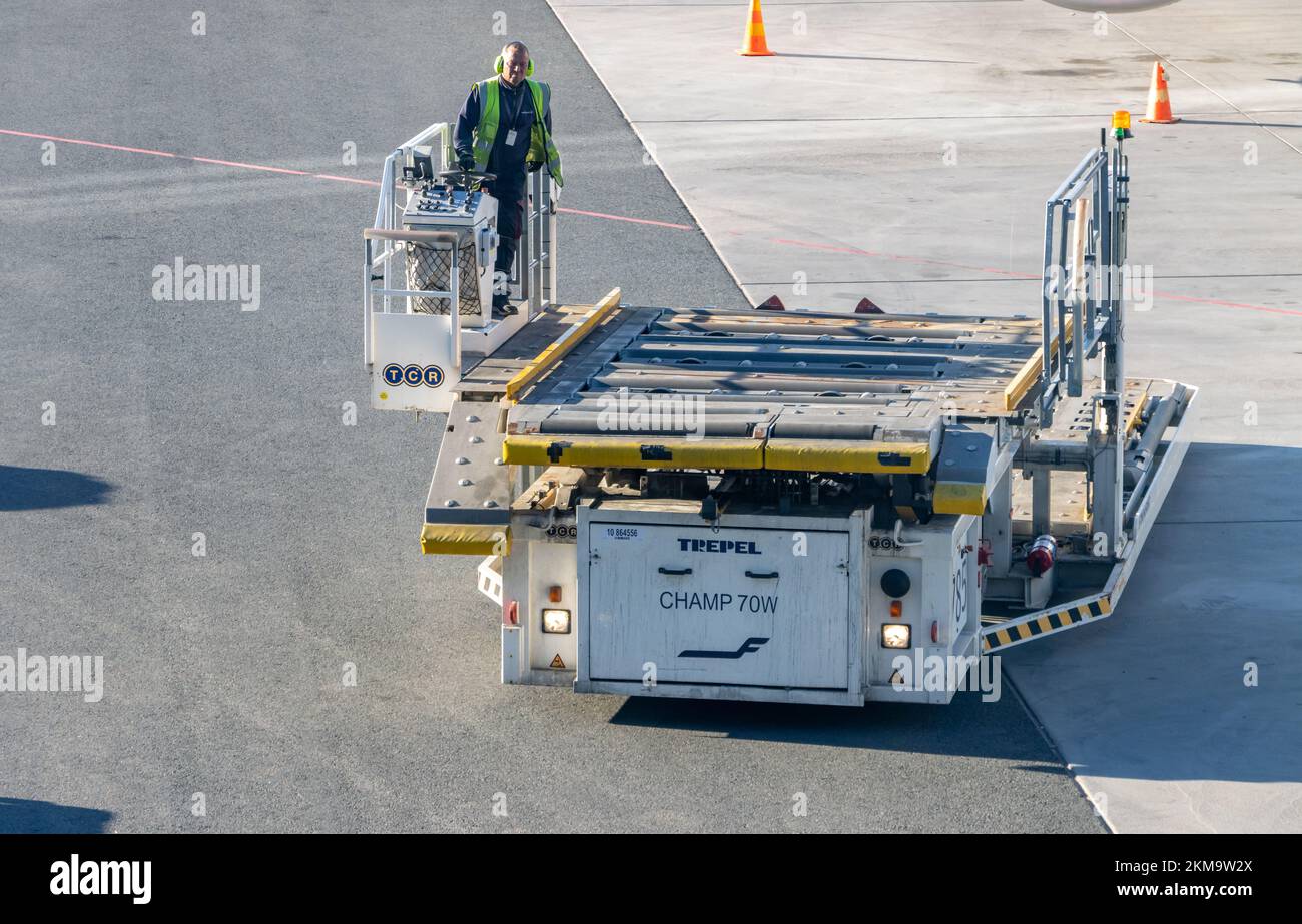 An empty vehicle - cargo high loader rides on a runway, Helsinki, Finland Stock Photo