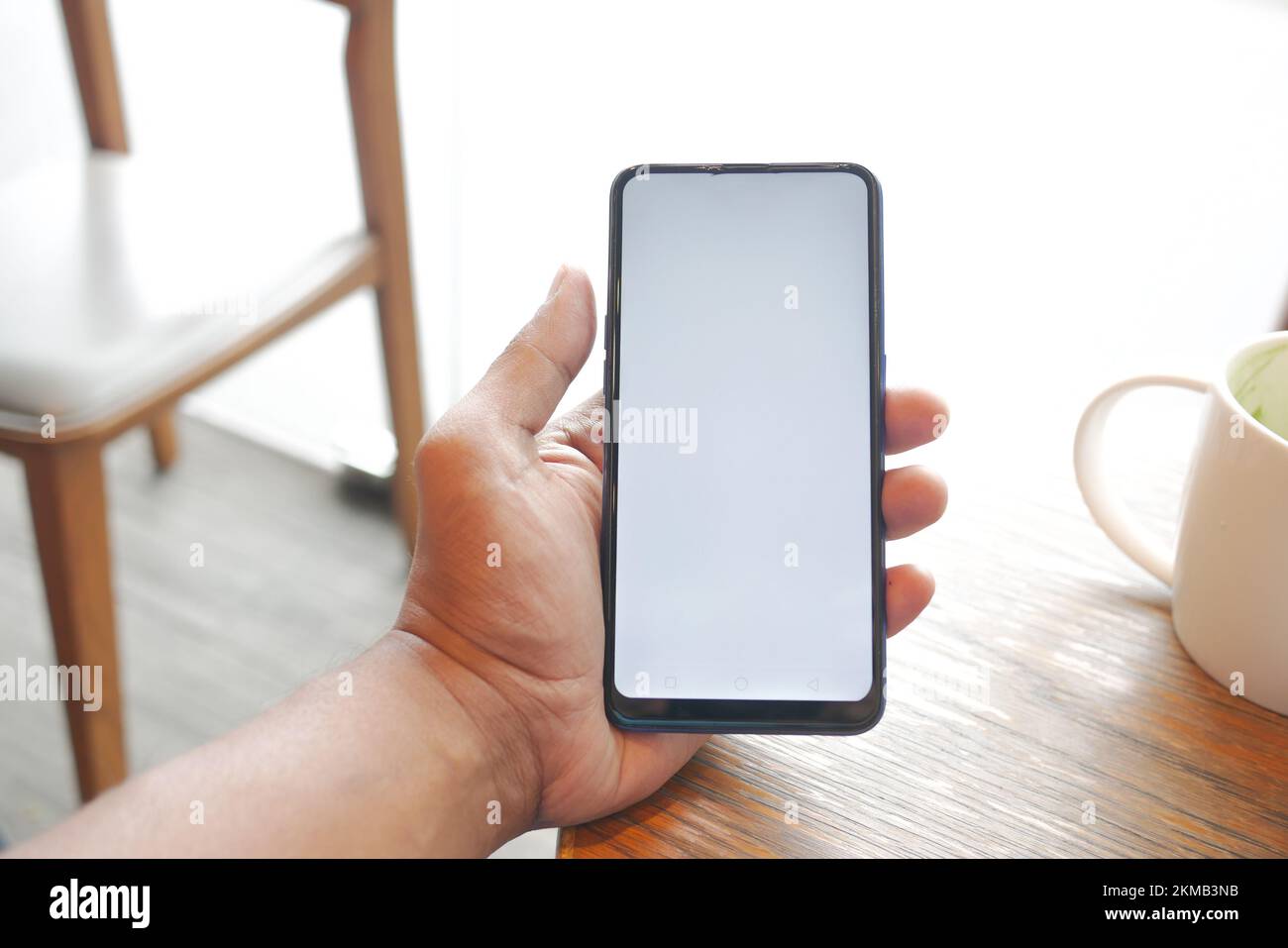 young man hand using smart phone with green screen at cafe Stock Photo ...