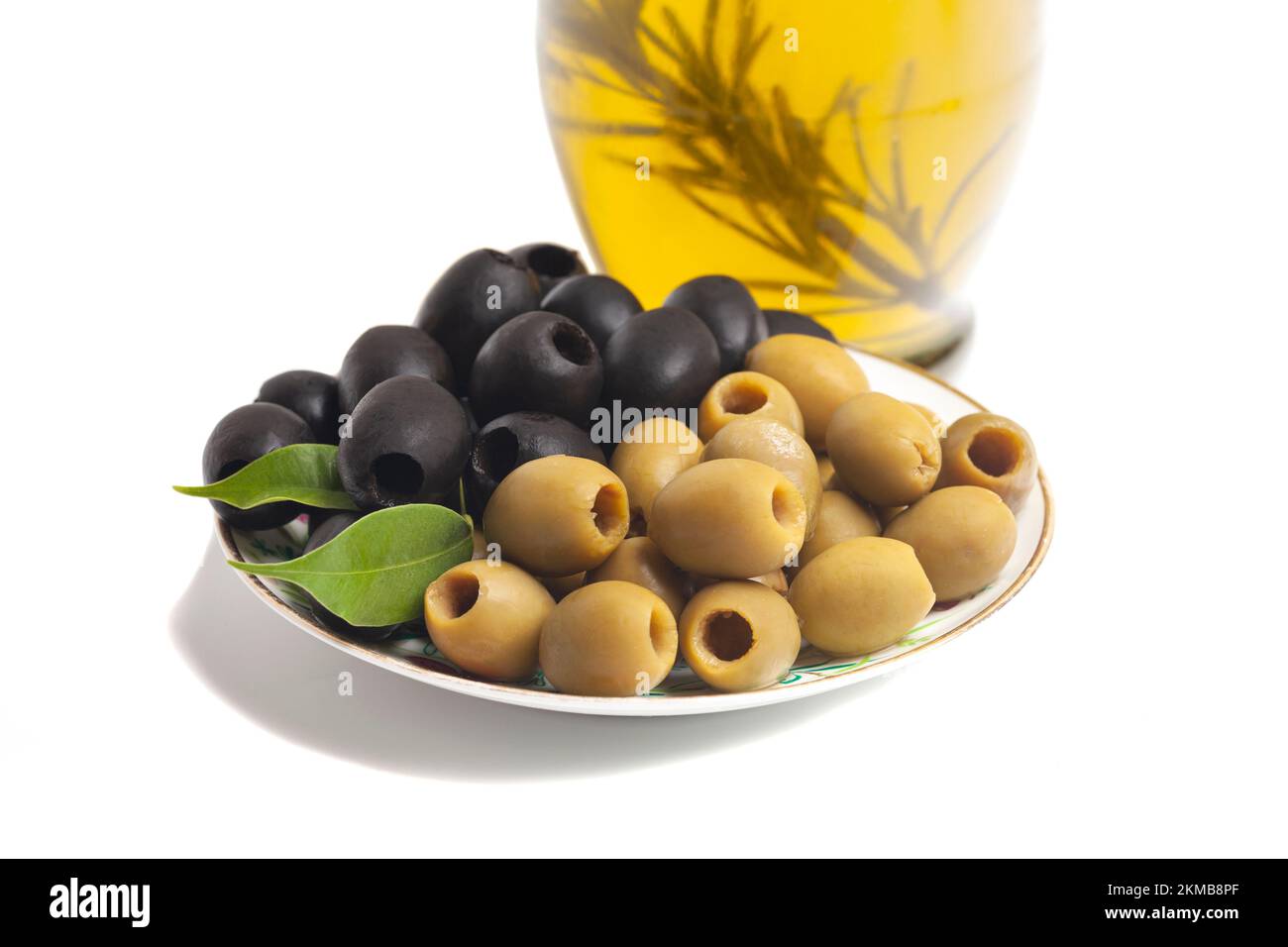 Jug with olive oil, green and black olives isolated on white background. Stock Photo