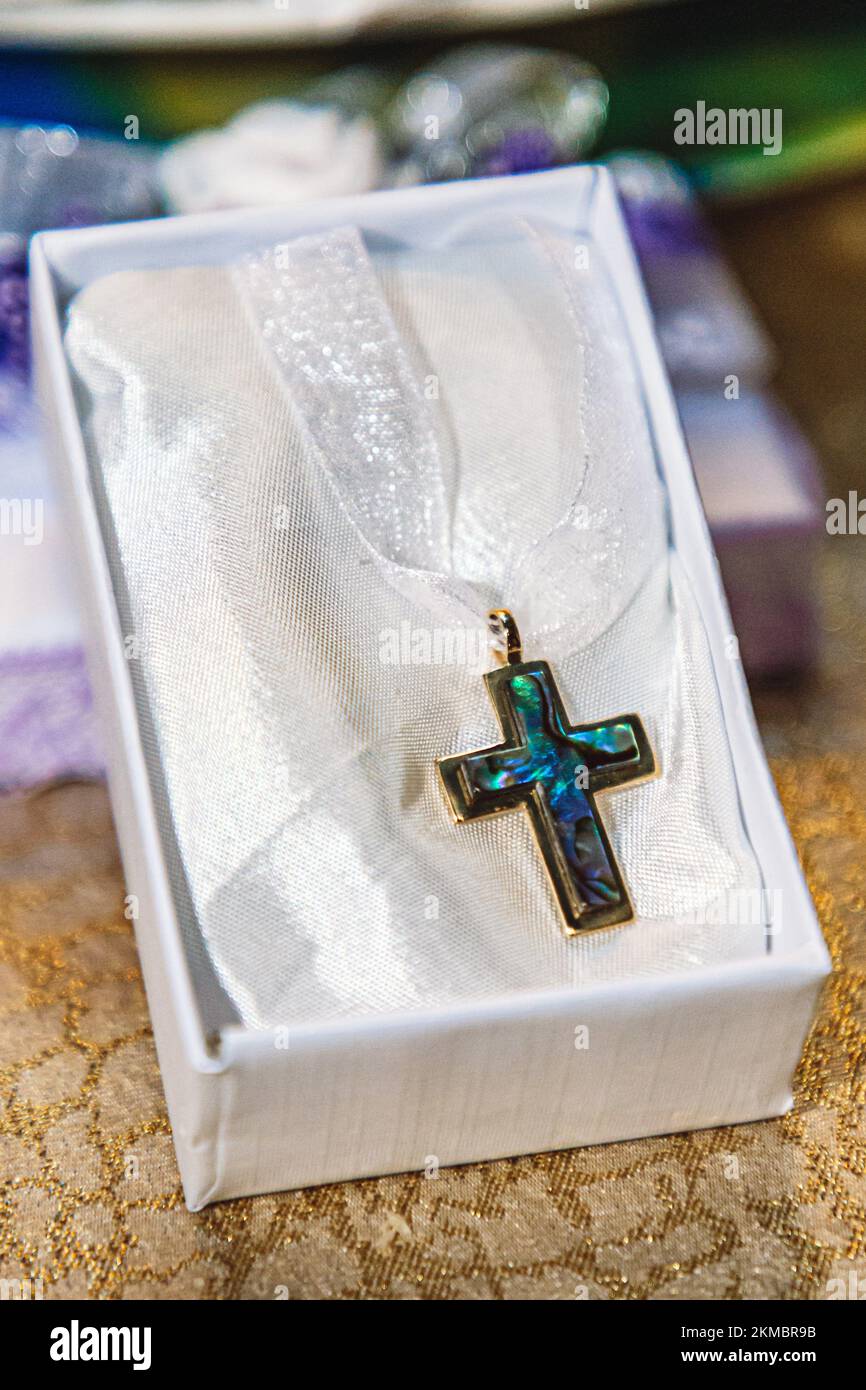 A vertical closeup of a beautiful cross in the white box Stock Photo ...