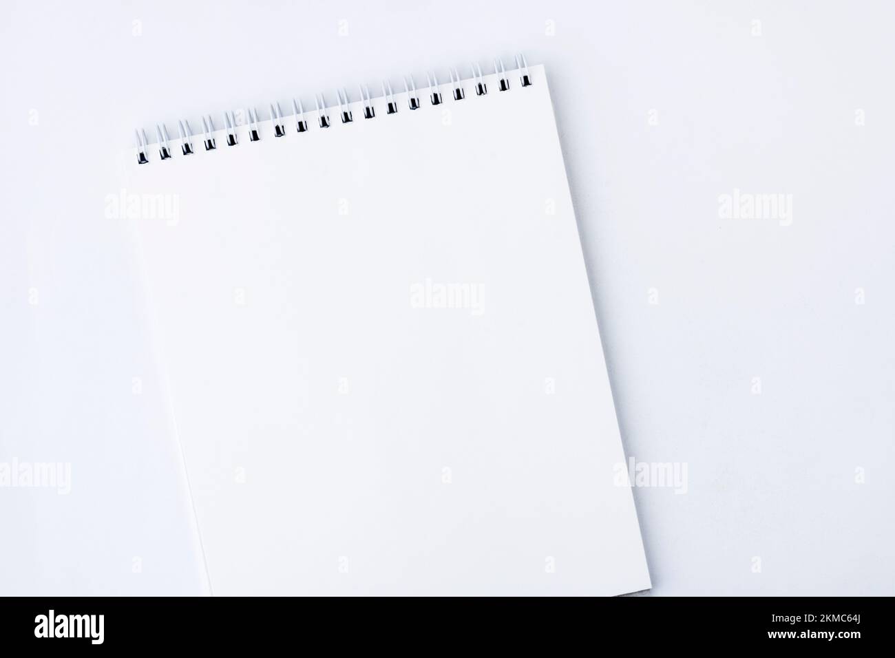 White open notebook. White notebook with spiral mount pages, on a white background. Copy space Stock Photo