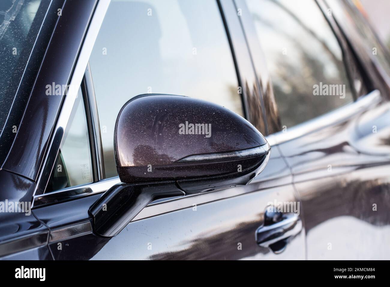 Close up front view of car side mirror. Front rear view mirror on the car window. Car exterior details. Stock Photo