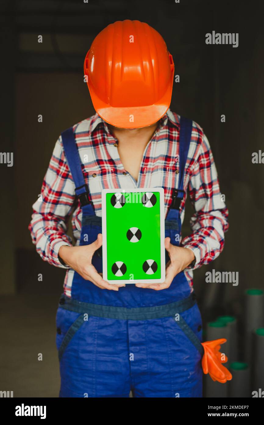 woman construction manager holding tablet device with green screen. Architect or designer Stock Photo