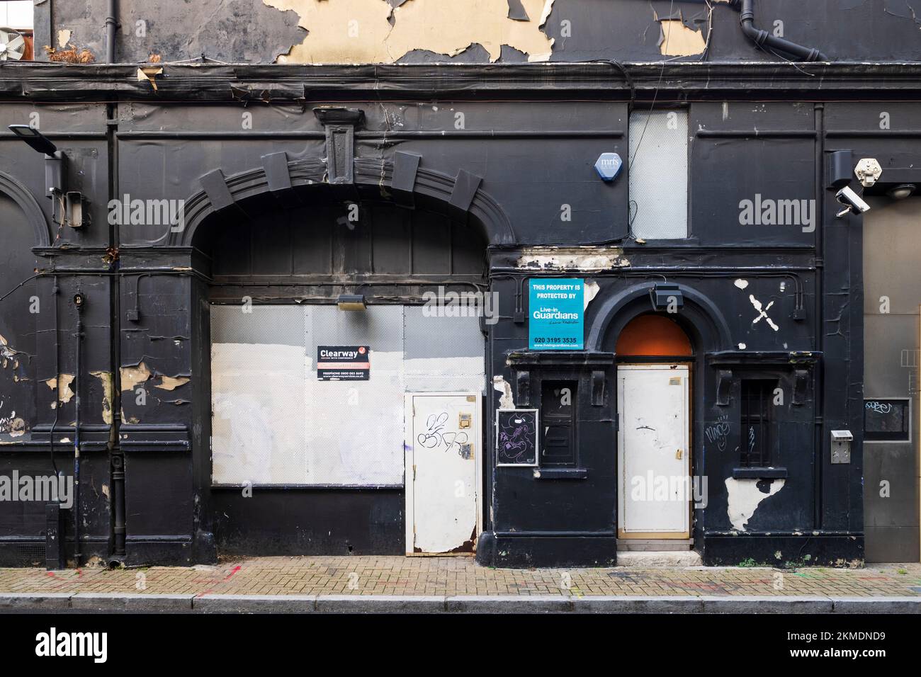 A closed down shop with its windows boarded up, West Central Street, London, UK.  25 Nov 2022 Stock Photo