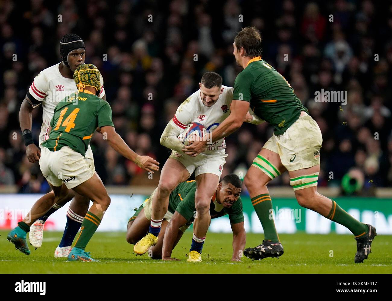 England's Jonny May (centre) is tackled by South Africa's Kurt-Lee Arendse (left) and Eben Etzebeth (right) during the Autumn International match at Twickenham Stadium, London. Picture date: Saturday November 26, 2022. Stock Photo