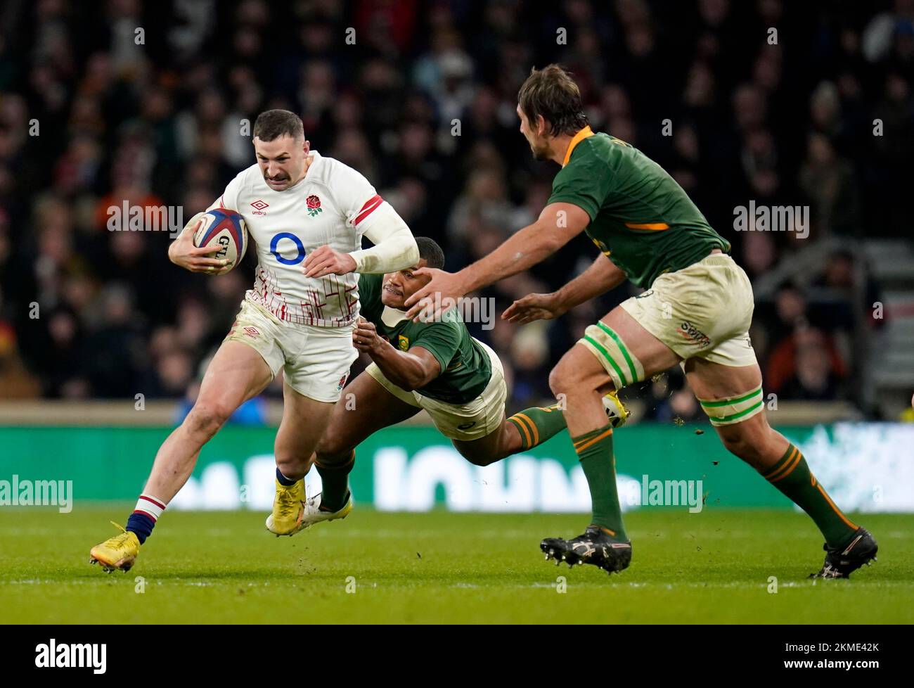 England's Jonny May (left) is tackled by South Africa's Damian Willemse (centre) and Eben Etzebeth (right) during the Autumn International match at Twickenham Stadium, London. Picture date: Saturday November 26, 2022. Stock Photo