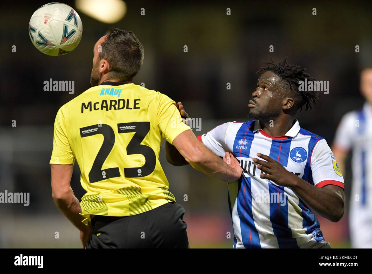 Hartlepool, UK. 19th Nov, 2022. Hartlepool United's Chris Missilou and Harrogate Town's Rory McArdle watch the ball during the FA Cup Second Round match between Hartlepool United and Harrogate Town at Victoria Park, Hartlepool on Saturday 26th November 2022. (Credit: Scott Llewellyn | MI News) Credit: MI News & Sport /Alamy Live News Stock Photo
