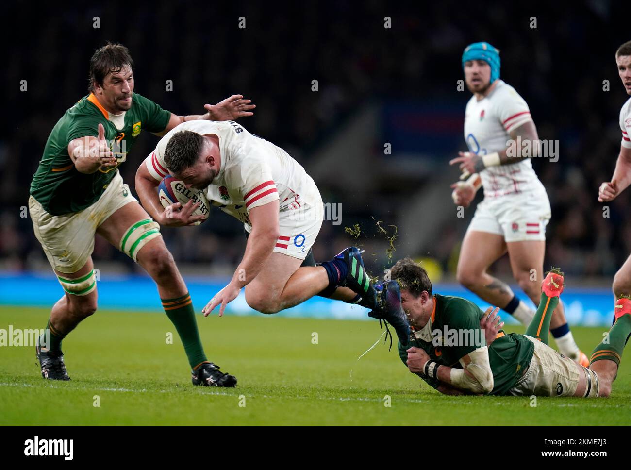 England's Will Stuart (centre) is tackled by South Africa's Eben Etzebeth (left) and Franco Mostert (right) during the Autumn International match at Twickenham Stadium, London. Picture date: Saturday November 26, 2022. Stock Photo