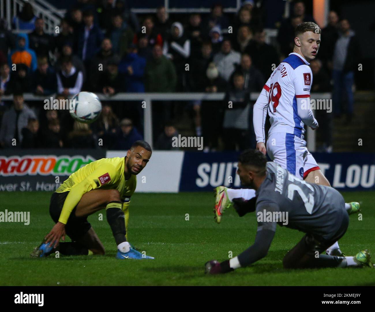 Harrogate Town Goalkeeper Pete Jameson saves from Hartlepool United's Jack Hamilton during the FA Cup Second Round between Hartlepool United and Harrogate Town at Victoria Park, Hartlepool on Saturday 26th November 2022. (Credit: Michael Driver | MI News) Credit: MI News & Sport /Alamy Live News Stock Photo