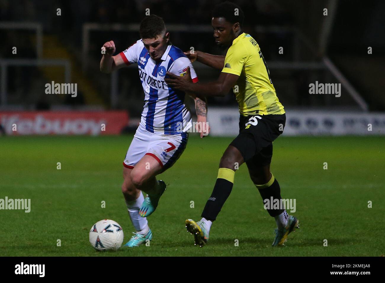Hartlepool United's Jake Hastie takes on Harrogate Town's Jaheim Headley during the FA Cup Second Round between Hartlepool United and Harrogate Town at Victoria Park, Hartlepool on Saturday 26th November 2022. (Credit: Michael Driver | MI News) Credit: MI News & Sport /Alamy Live News Stock Photo