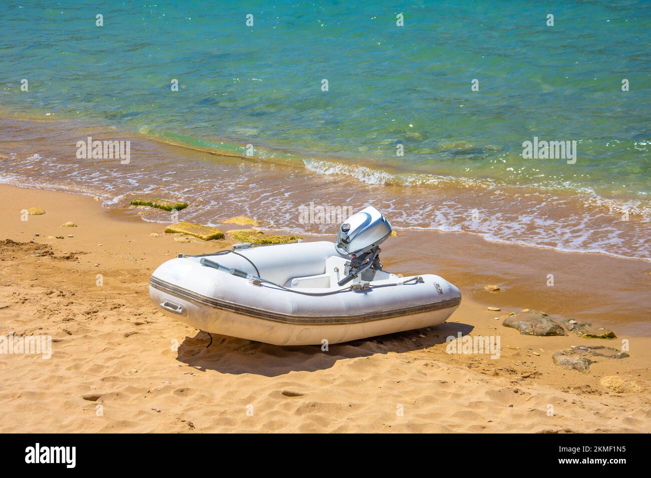 Inflatable motorboat on the sandy beach of the Mediterranean Stock Photo