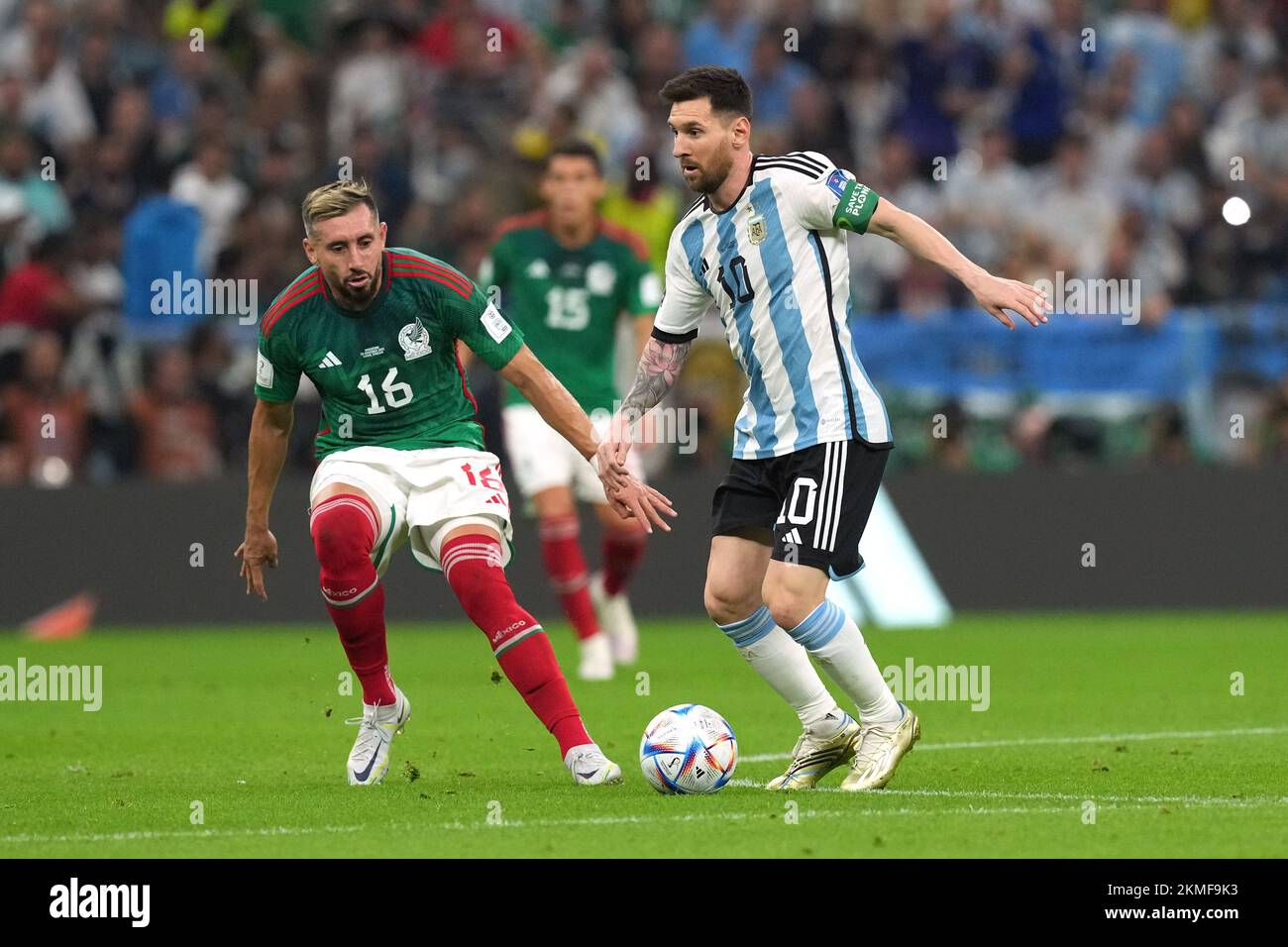 Argentina's Lionel Messi (right) and Mexico's Hector Herrera battle for the ball during the FIFA World Cup Group C match at the Lusail Stadium in Lusail, Qatar. Picture date: Saturday November 26, 2022. Stock Photo