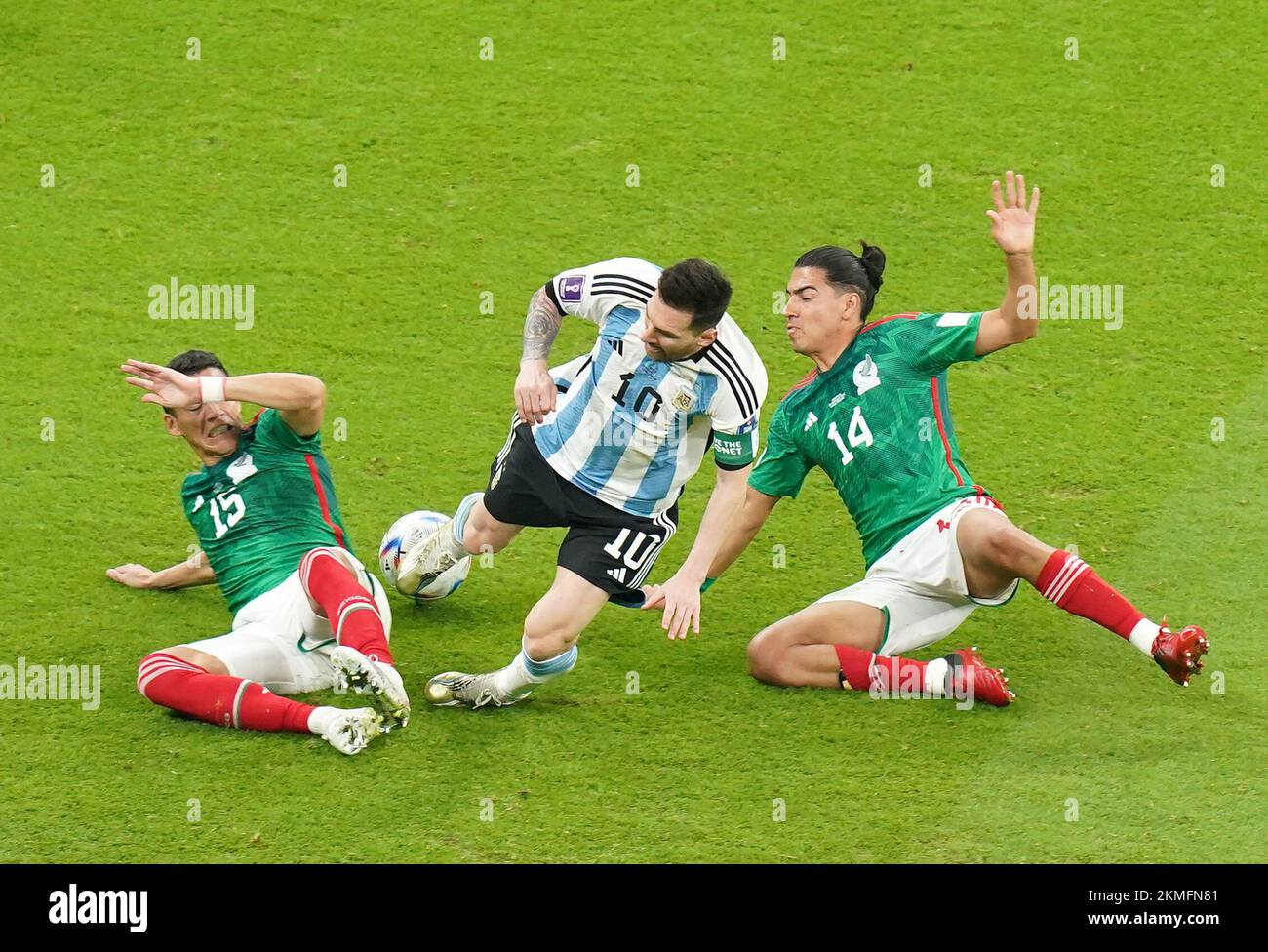 Mexico's Hector Moreno (left) and Erick Gutierrez (right) take down Argentina's Lionel Messi (centre) during the FIFA World Cup Group C match at the Lusail Stadium in Lusail, Qatar. Picture date: Saturday November 26, 2022. Stock Photo