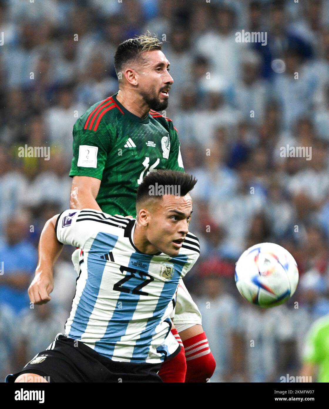 Lusail, Qatar. 26th Nov, 2022. Lautaro Martinez (Bottom) of Argentina vies with Hector Herrera of Mexico during the Group C match between Argentina and Mexico at the 2022 FIFA World Cup at Lusail Stadium in Lusail, Qatar, Nov. 26, 2022. Credit: Li Ga/Xinhua/Alamy Live News Stock Photo