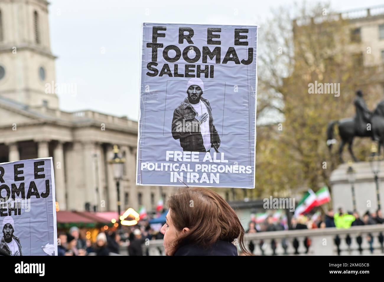 Trafalgar square, London, UK. 26th November 2022: Protest anti-Iran government and Qatar World Cup protesters waving flags and banners criticising Tehran as well as holding up a football and a fake World Cup trophy smeared in fake blood. Stock Photo