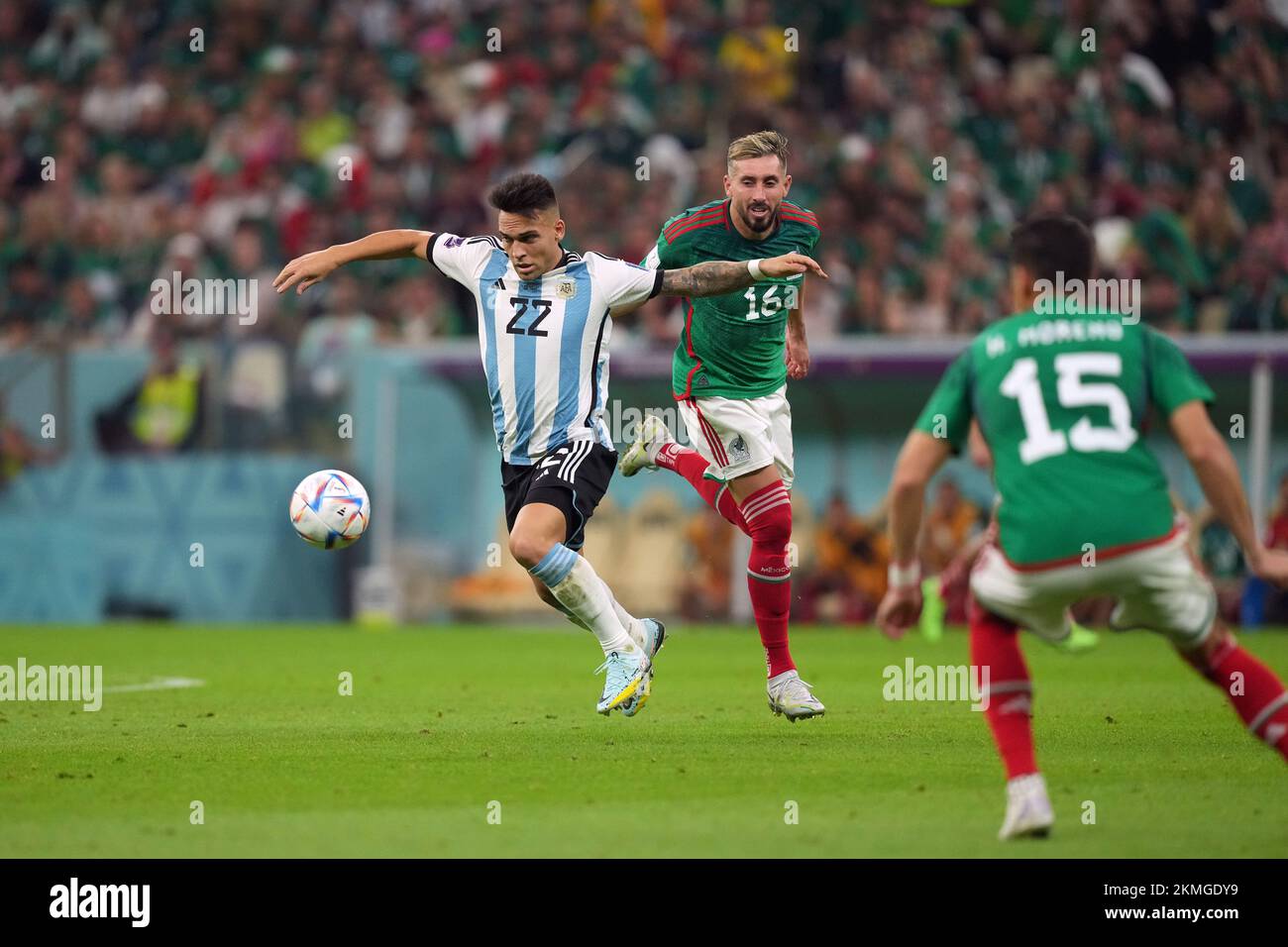 Argentina's Lautaro Martinez (left) and Mexico's Hector Herrera (centre) battle for the ball during the FIFA World Cup Group C match at the Lusail Stadium in Lusail, Qatar. Picture date: Saturday November 26, 2022. Stock Photo