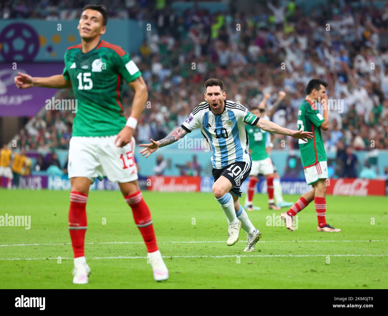 Lusail, Qatar. 26th Nov, 2022. Soccer, World Cup, Argentina - Mexico, Preliminary Round, Group C, Matchday 2, Lusail Iconic Stadium, Lionel Messi (M) of Argentina cheers after scoring to make it 1-0. Hector Moreno of Mexico is on the left. Hirving Lozano of Mexico walks in the background on the right. Credit: Tom Weller/dpa/Alamy Live News Stock Photo