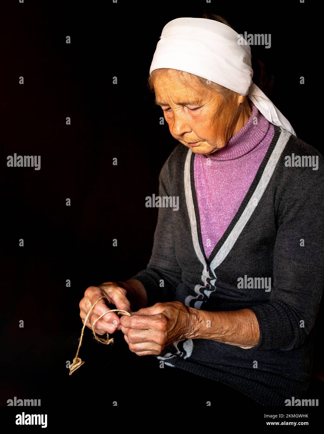 Elderly dame. Hands of old woman with polyarthritis disease. Canvas strings on fingers of elderly lady, puppets. High quality photo Stock Photo