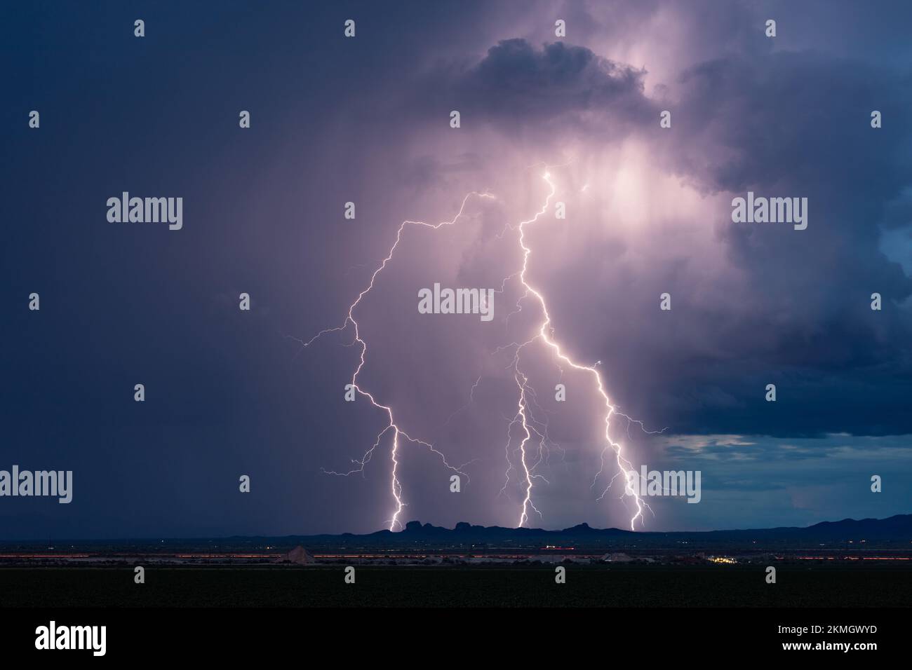 Intense lightning bolt strikes and dark storm clouds from a thunderstorm near Tucson, Arizona