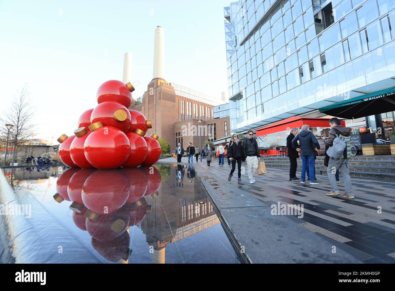 Giant Christmas baubles outside the reopened, iconic Battersea Power Station, in SW London, UK Stock Photo