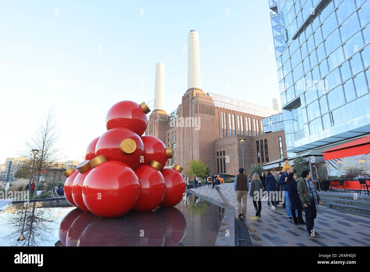 Giant Christmas baubles outside the reopened, iconic Battersea Power Station, in SW London, UK Stock Photo