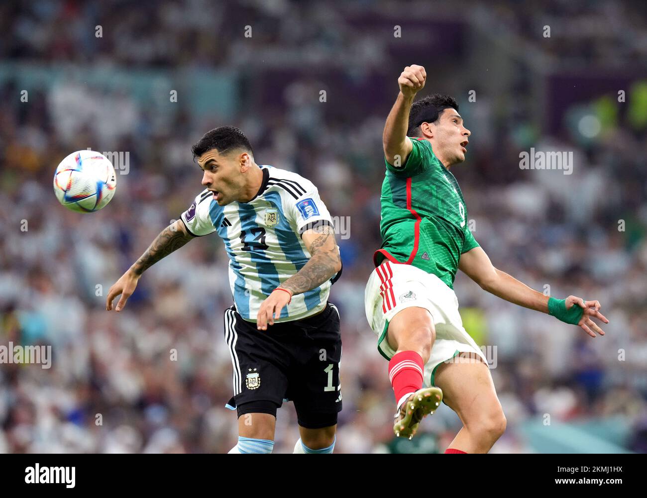 Argentina's Cristian Romero (left) and Mexico's Raul Jimenez battle for the ball during the FIFA World Cup Group C match at the Lusail Stadium in Lusail, Qatar. Picture date: Saturday November 26, 2022. Stock Photo