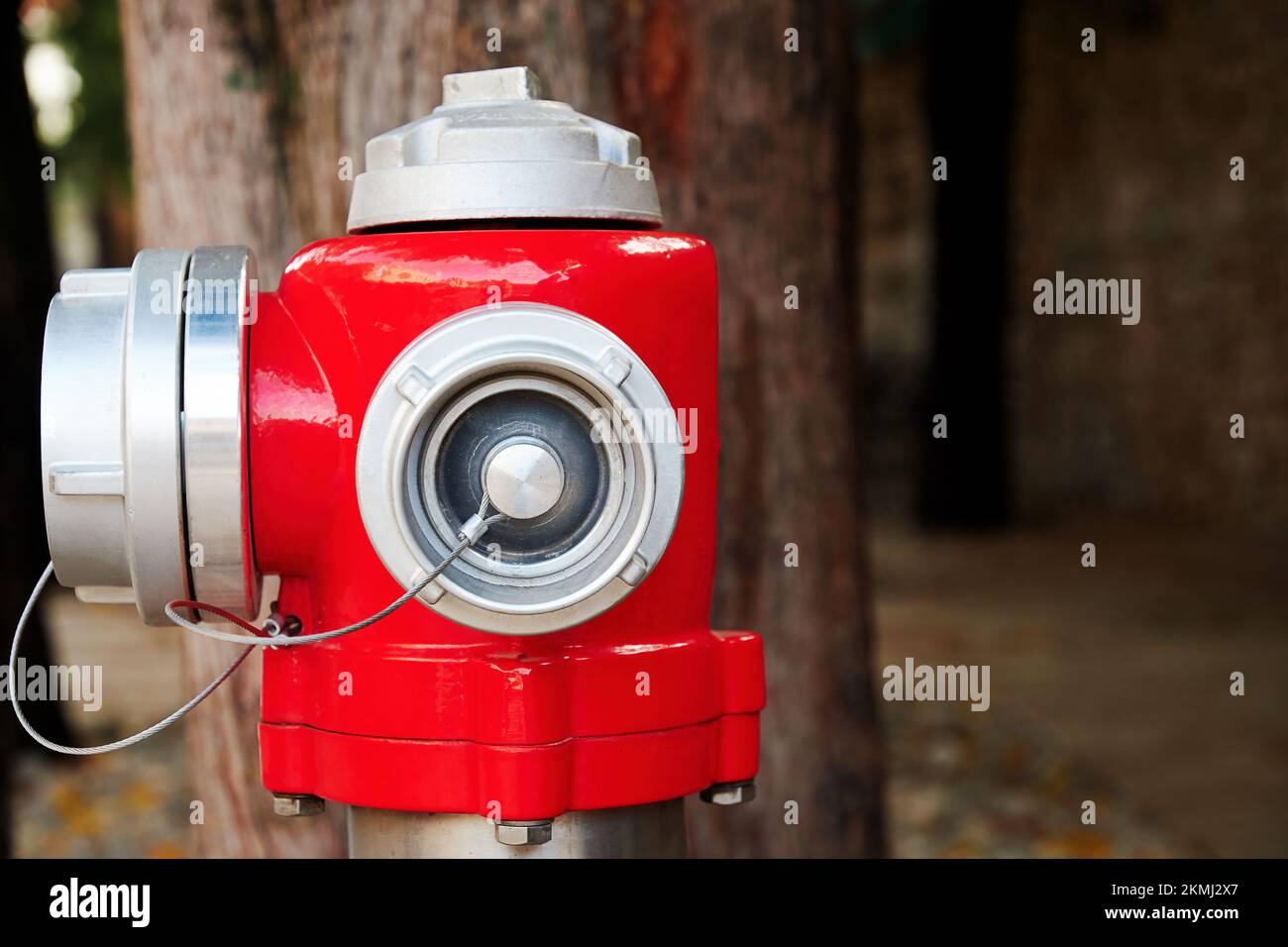 Red public fire hydrant on the street. Fire supplies and equipment for