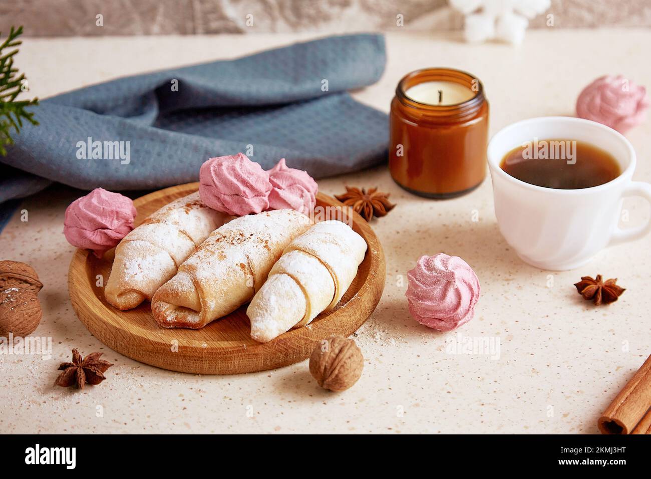 Aesthetics Christmas food background - crescent bagels and marshmallow, walnuts, star anise, coffee. Cozy home. Stock Photo