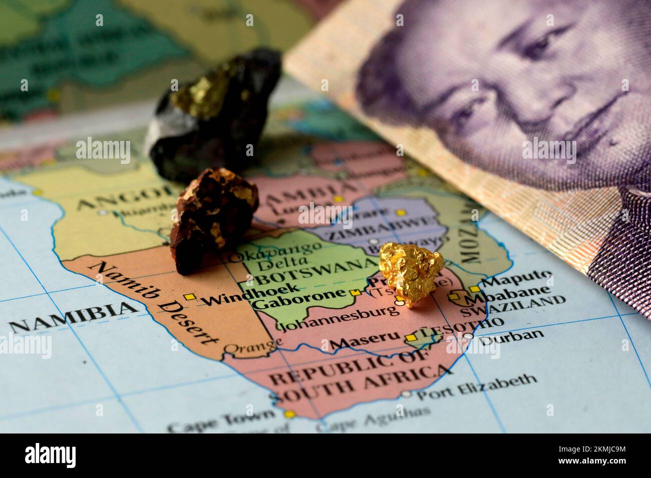 Closeup of a yuan Chinese banknote and rare earth metals on top of a map of Africa Stock Photo