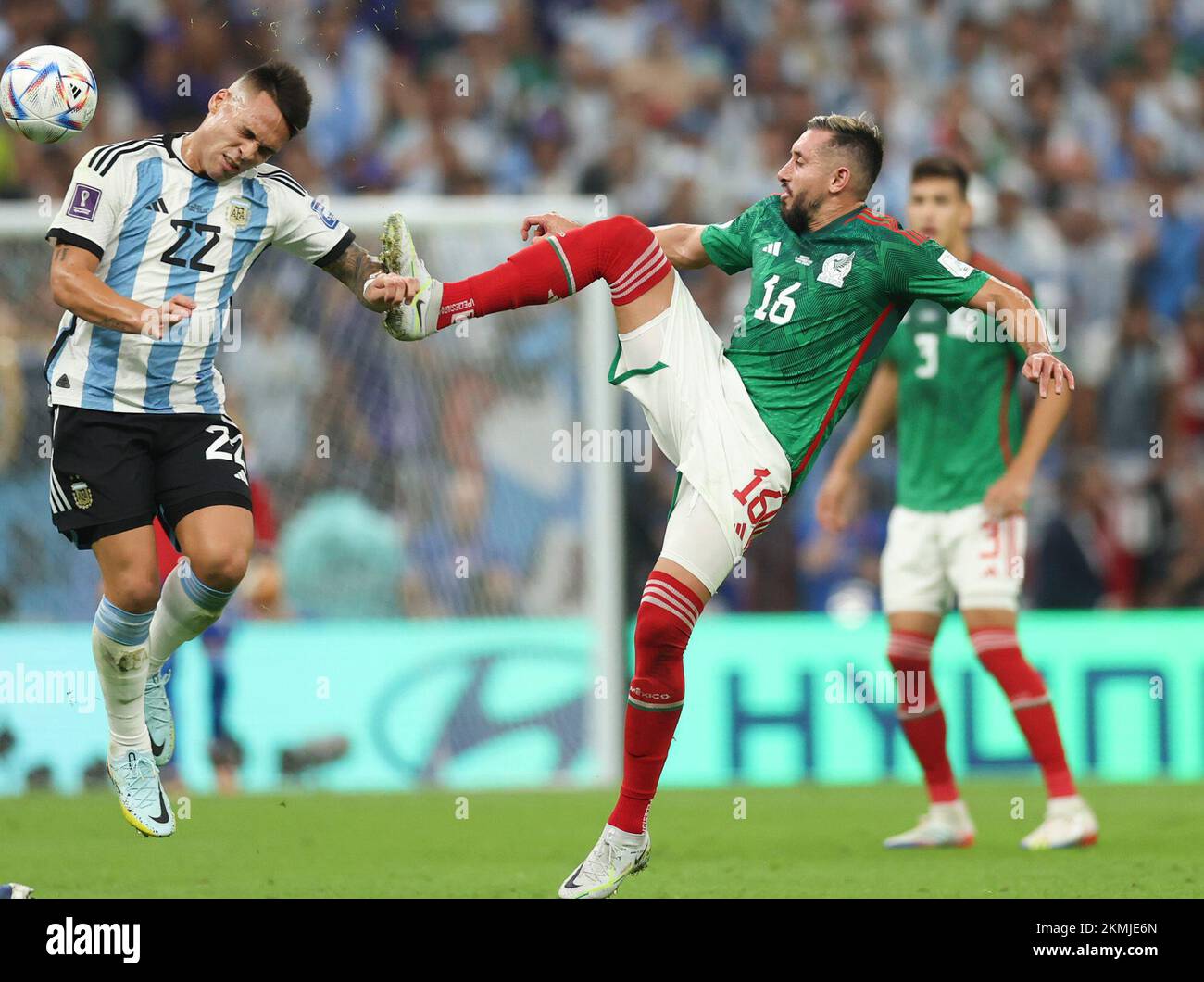 Lusail, Qatar. 26th Nov, 2022. Hector Herrera (C) of Mexico vies with Lautaro Martinez (L) of Argentina during the Group C match between Argentina and Mexico at the 2022 FIFA World Cup at Lusail Stadium in Lusail, Qatar, Nov. 26, 2022. Credit: Pan Yulong/Xinhua/Alamy Live News Stock Photo