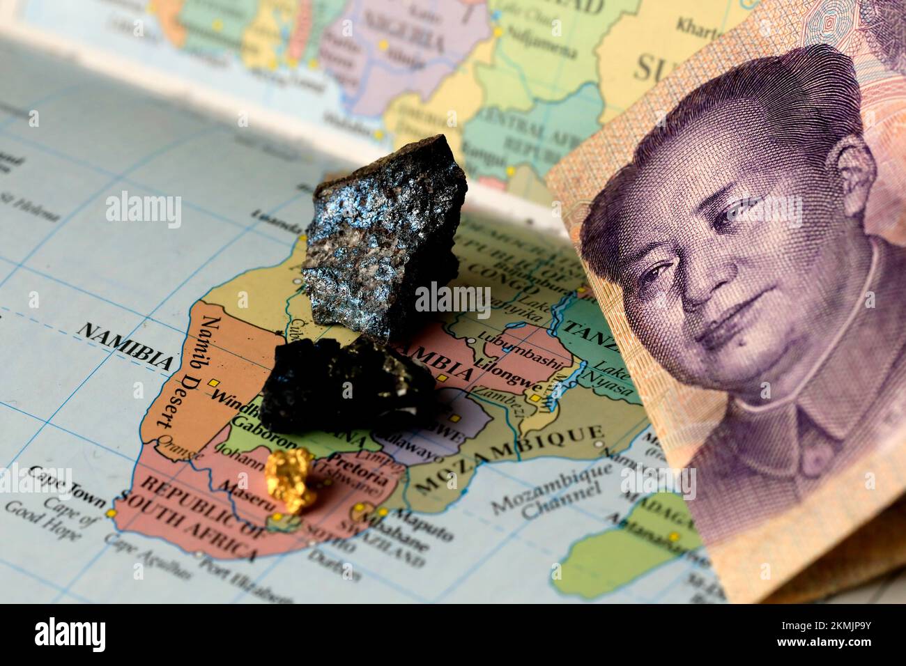 Closeup of a yuan Chinese banknote and rare earth metals on top of a map of Africa Stock Photo