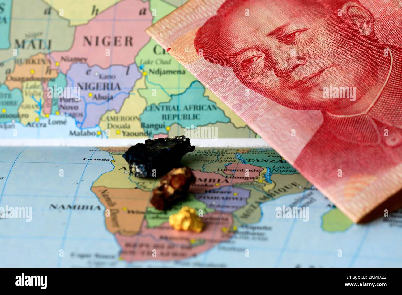 Closeup of a yuan Chinese banknote and rare earth metals on top of a map of Africa Stock Photo