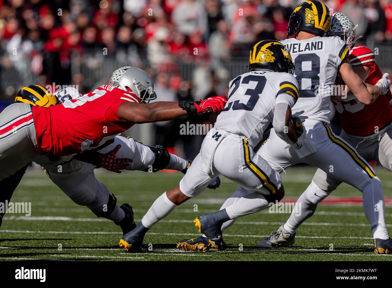 Columbus, Ohio, USA. 26th Nov, 2022. Michigan Wolverines running back C.J. Stokes (23) runs away from the tackle of Ohio State Buckeyes defensive tackle Ty Hamilton (58) during the game between the Michigan Wolverines and the Ohio State Buckeyes at Ohio Stadium, Columbus, Ohio. (Credit Image: © Scott Stuart/ZUMA Press Wire) Stock Photo