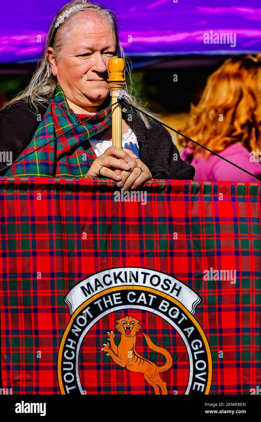 A woman holds a tartan representing the Mackintosh clan during the parade of clan tartans at the Scottish Highland Games in Gulfport, Mississippi. Stock Photo