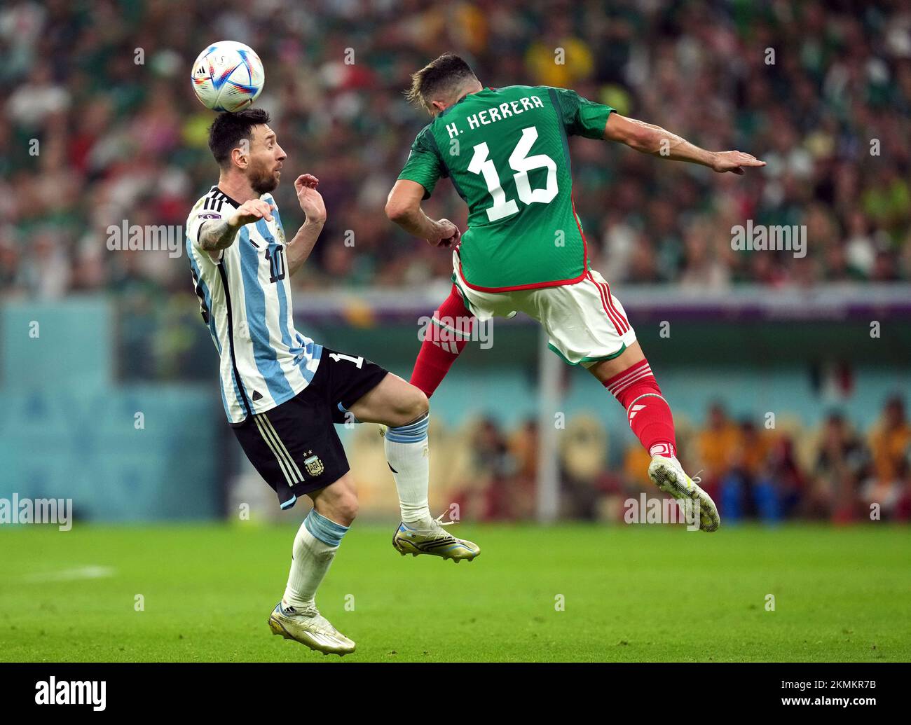 Argentina's Lionel Messi (left) and Mexico's Hector Herrera battle for the ball during the FIFA World Cup Group C match at the Lusail Stadium in Lusail, Qatar. Picture date: Saturday November 26, 2022. Stock Photo