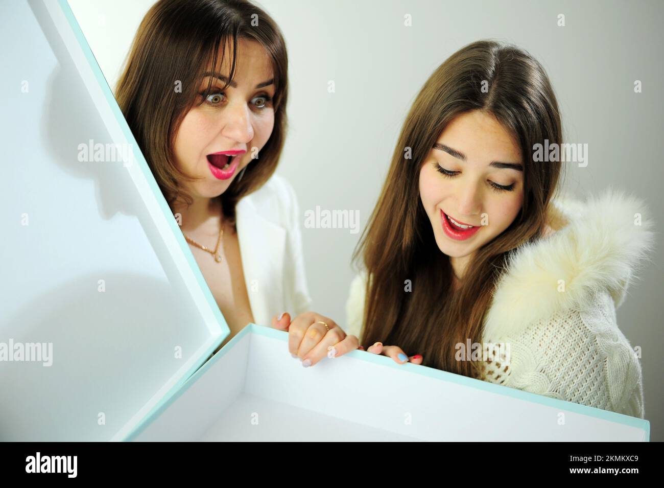 Mom and daughter look into Pale blue big boxes are surprised have fun ...