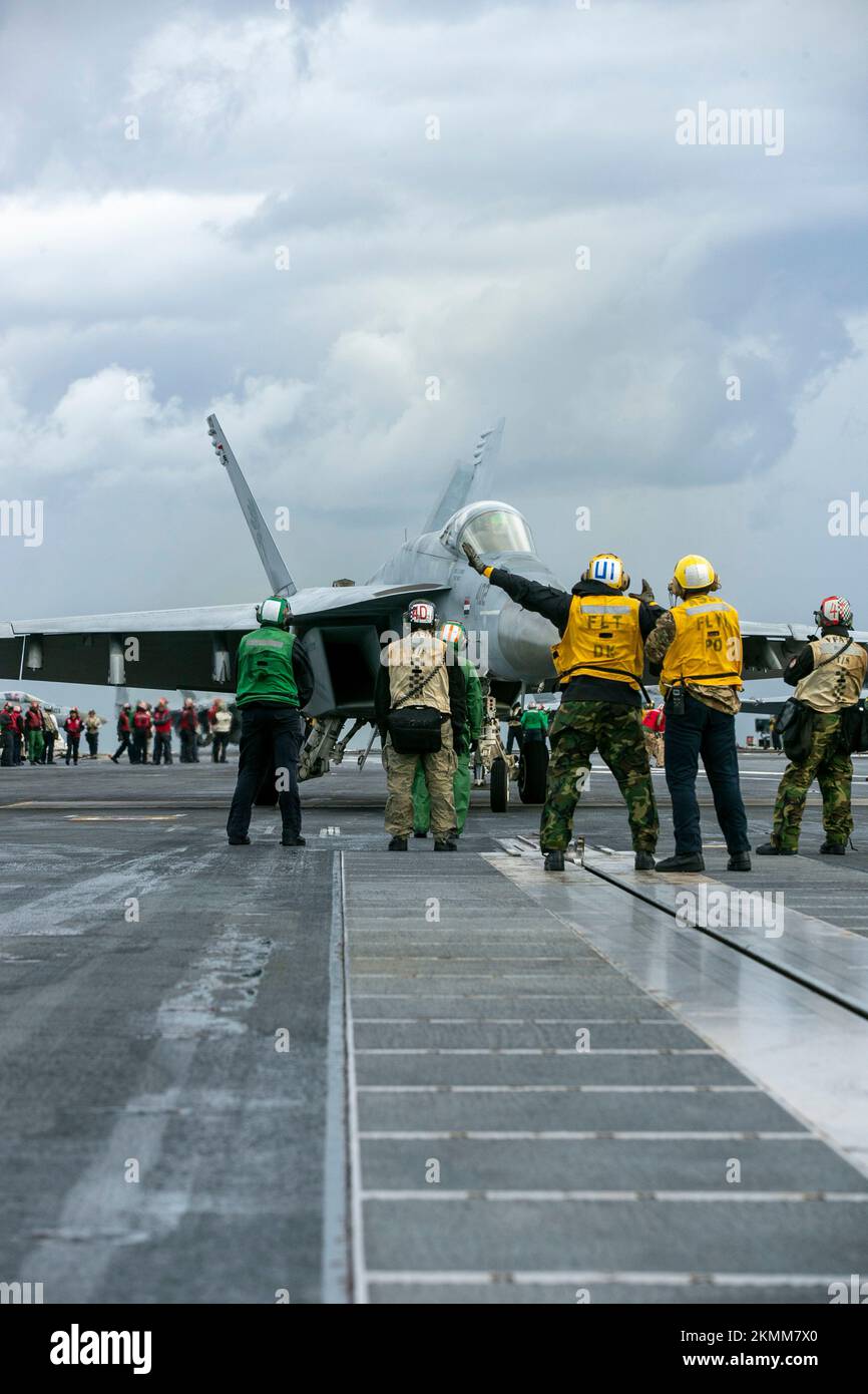 An F/A-18E Super Hornet, attached to the “Golden Warriors” of Strike Fighter Squadron (VFA) 87, prepares to depart the first-in-class aircraft carrier USS Gerald R. Ford (CVN 78) following the ship’s inaugural deployment, Nov. 25, 2022. More than 4,600 Sailors assigned to Ford operated in U.S. 2nd Fleet and 6th Fleet, increasing interoperability and interchangeability with NATO Allies and partners. Throughout the deployment, the Gerald R. Ford Carrier Strike Group sailed more than 9,200 miles, completed more than 1,250 sorties, expended 78.3 tons of ordnance, completed 13 underway replenishmen Stock Photo