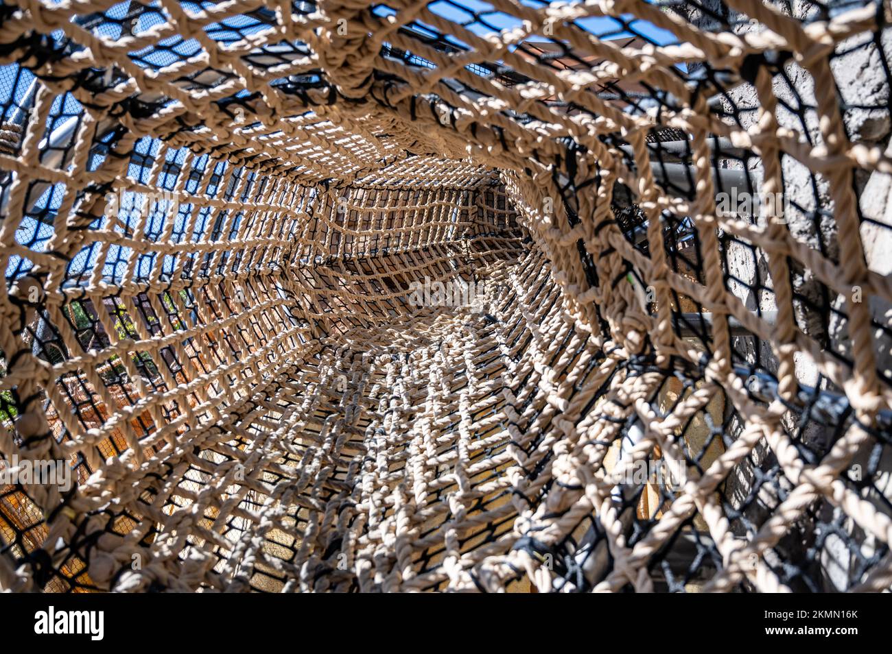 View down a long tunnel made of webbed rope at a child playground Stock ...