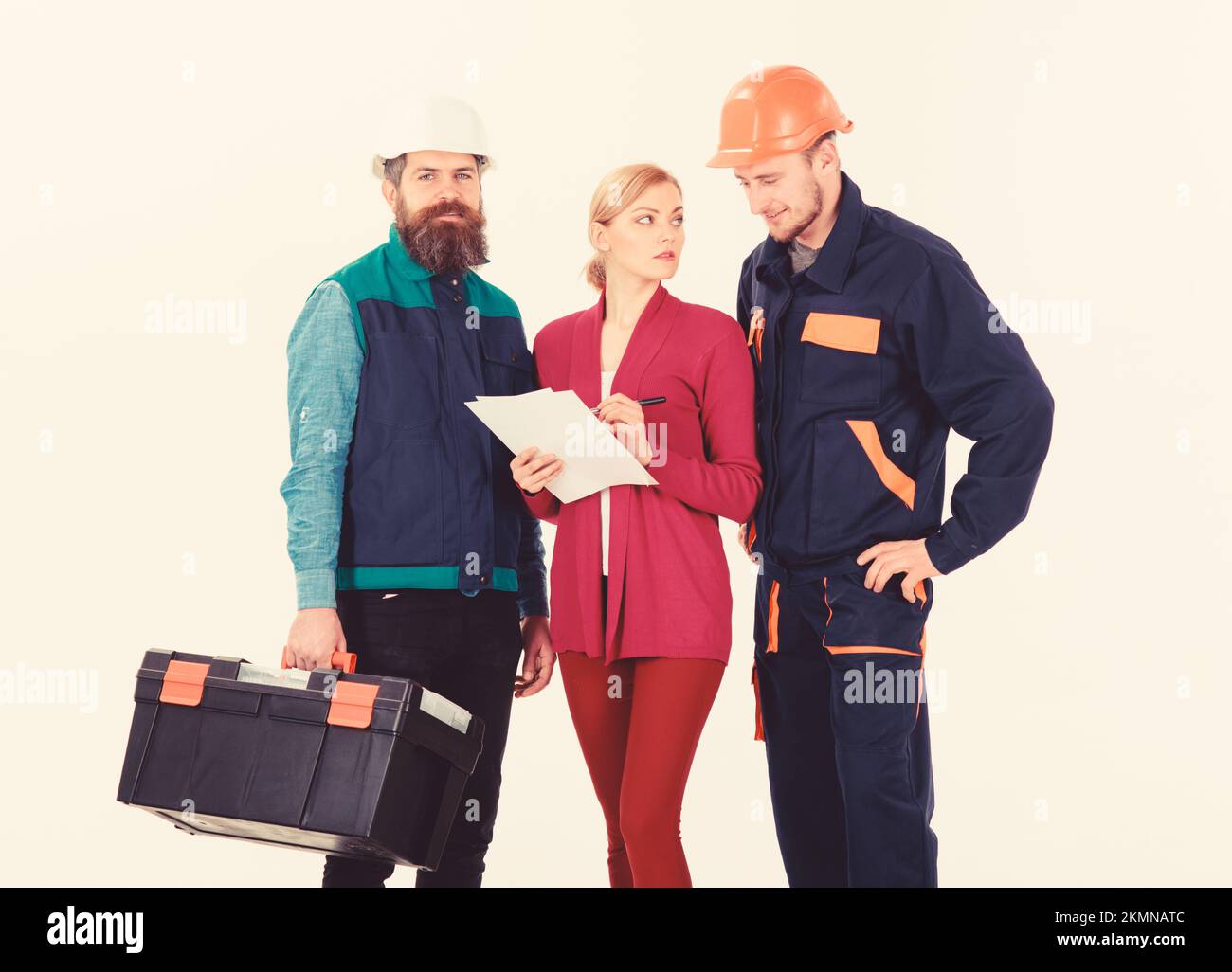 Men in hard hats and uniform and woman in suit Stock Photo - Alamy