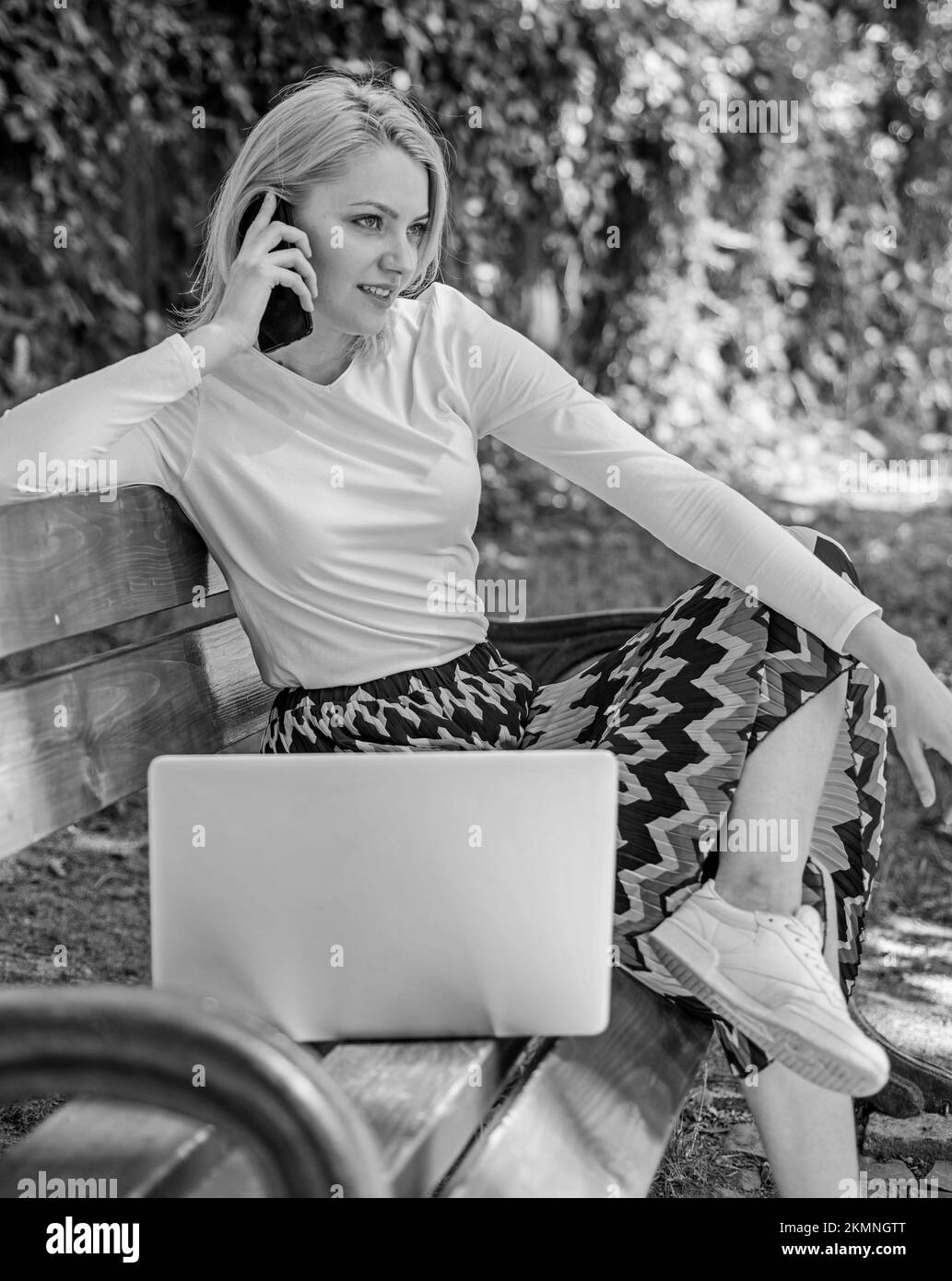 Girl dreamy takes advantage of online shopping. Girl sit bench with notebook call phone. Save your time with shopping online. Shopping online. Woman Stock Photo